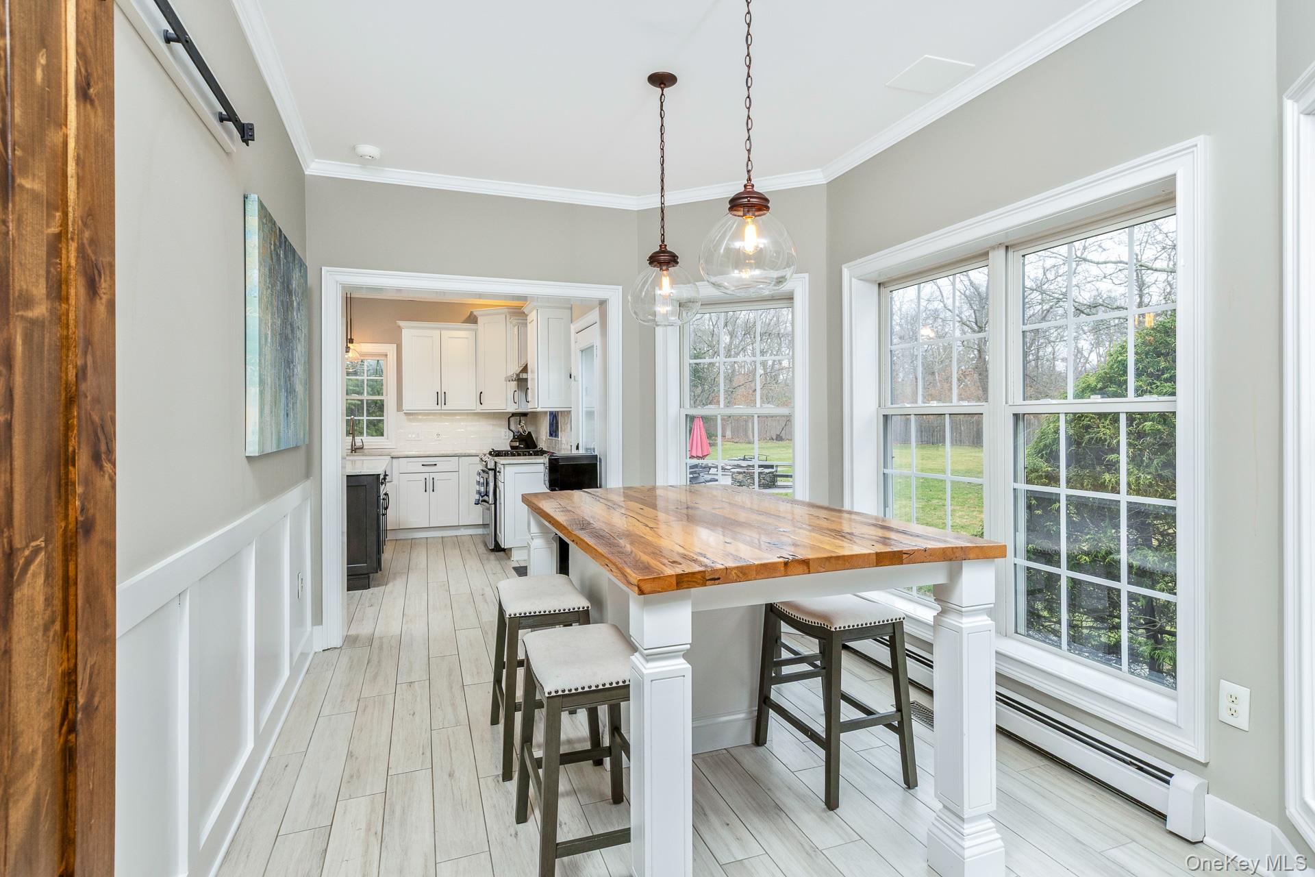 26 Box Tree Road East Quogue, NY 11942 - Photo 20 of 49 a room with stainless steel appliances granite countertop table chairs and a view of kitchen
