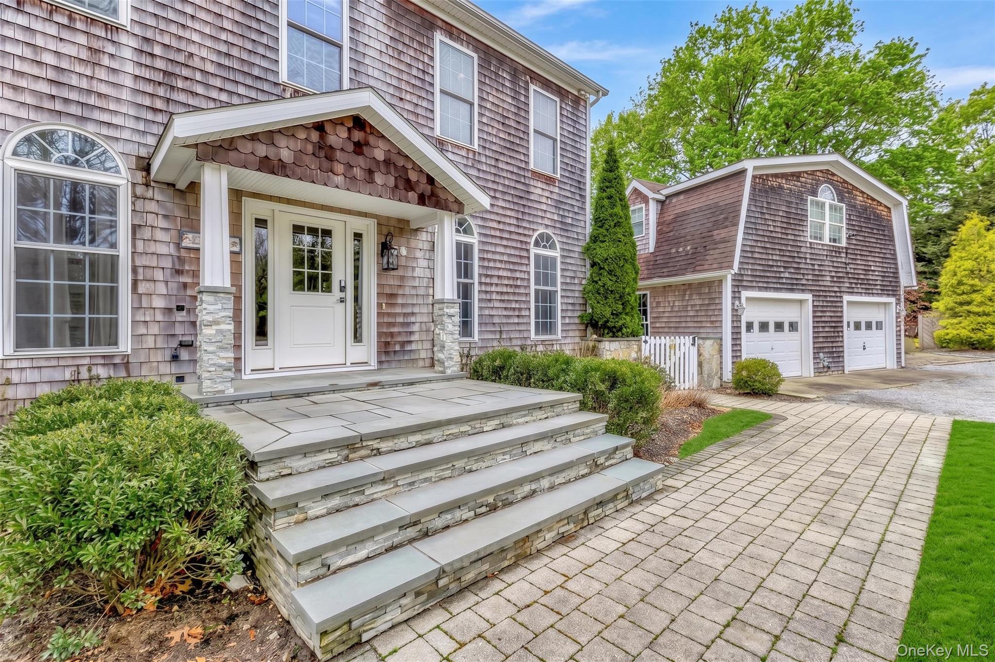 26 Box Tree Road East Quogue, NY 11942 - Photo 2 of 49 a front view of a house with garden