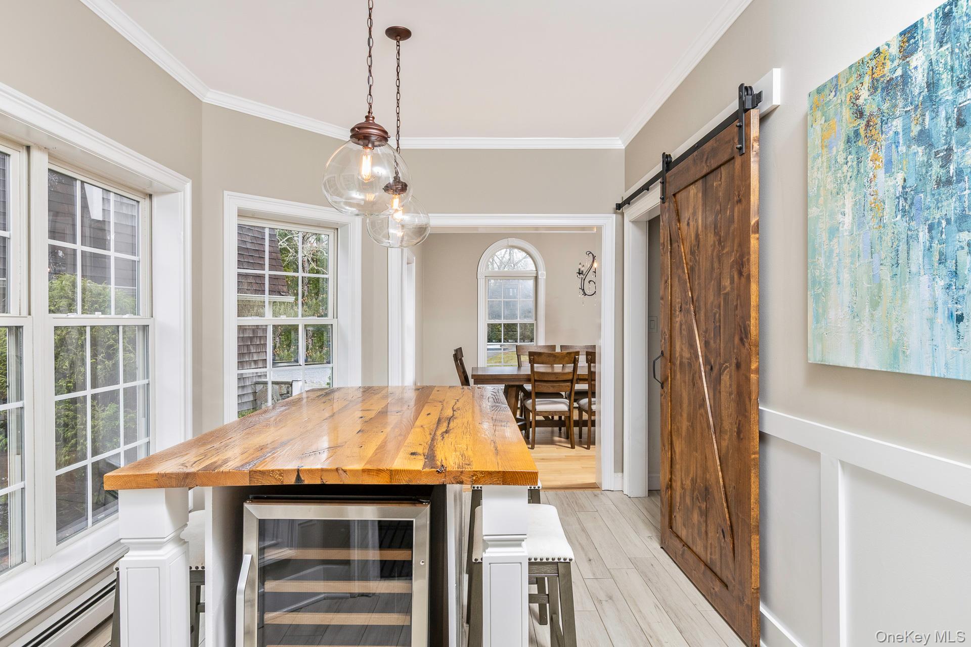 26 Box Tree Road East Quogue, NY 11942 - Photo 21 of 49 a view of a dining room with furniture window and wooden floor