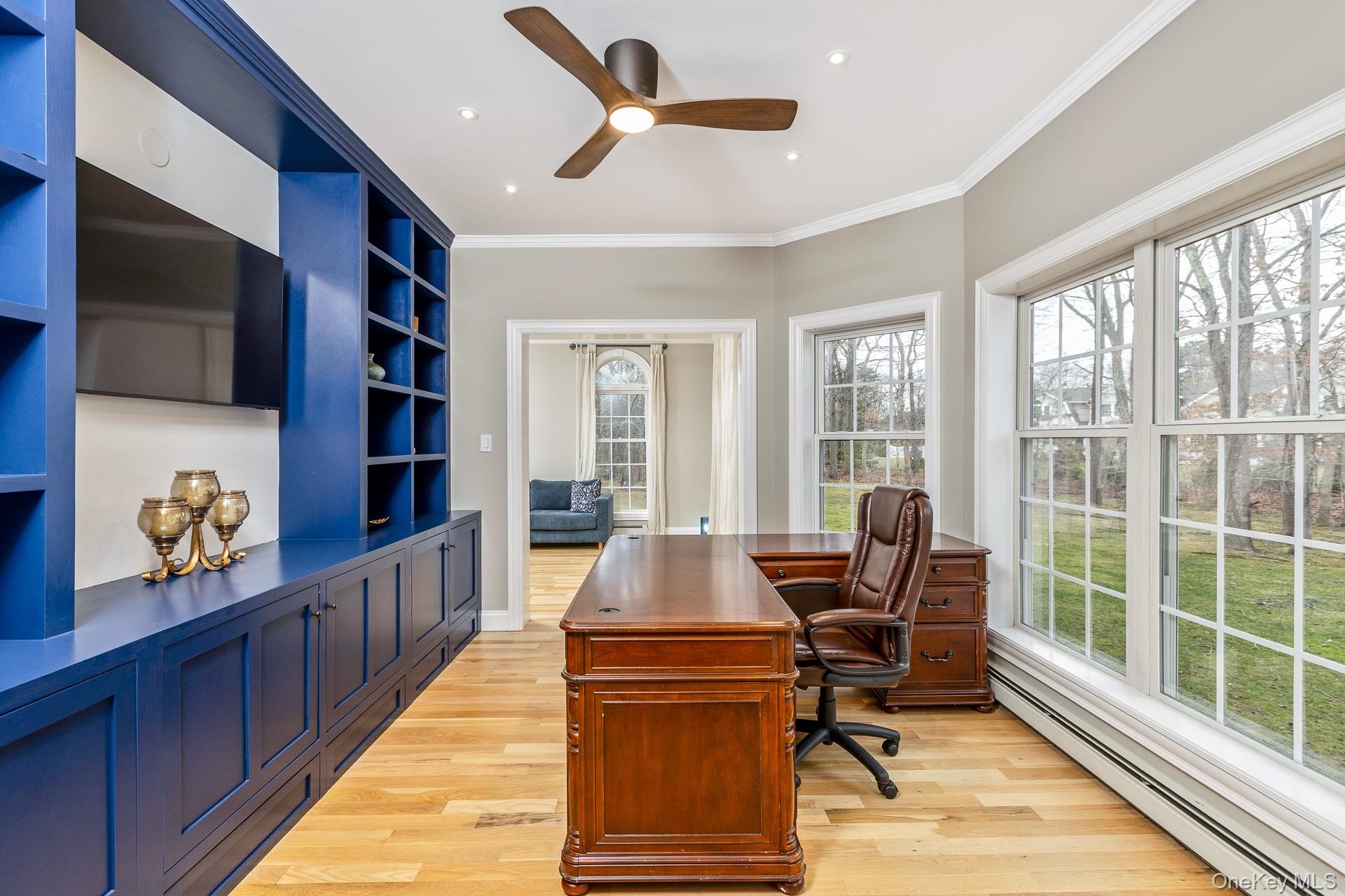 26 Box Tree Road East Quogue, NY 11942 - Photo 23 of 49 a living room with furniture flat screen tv and a floor to ceiling window