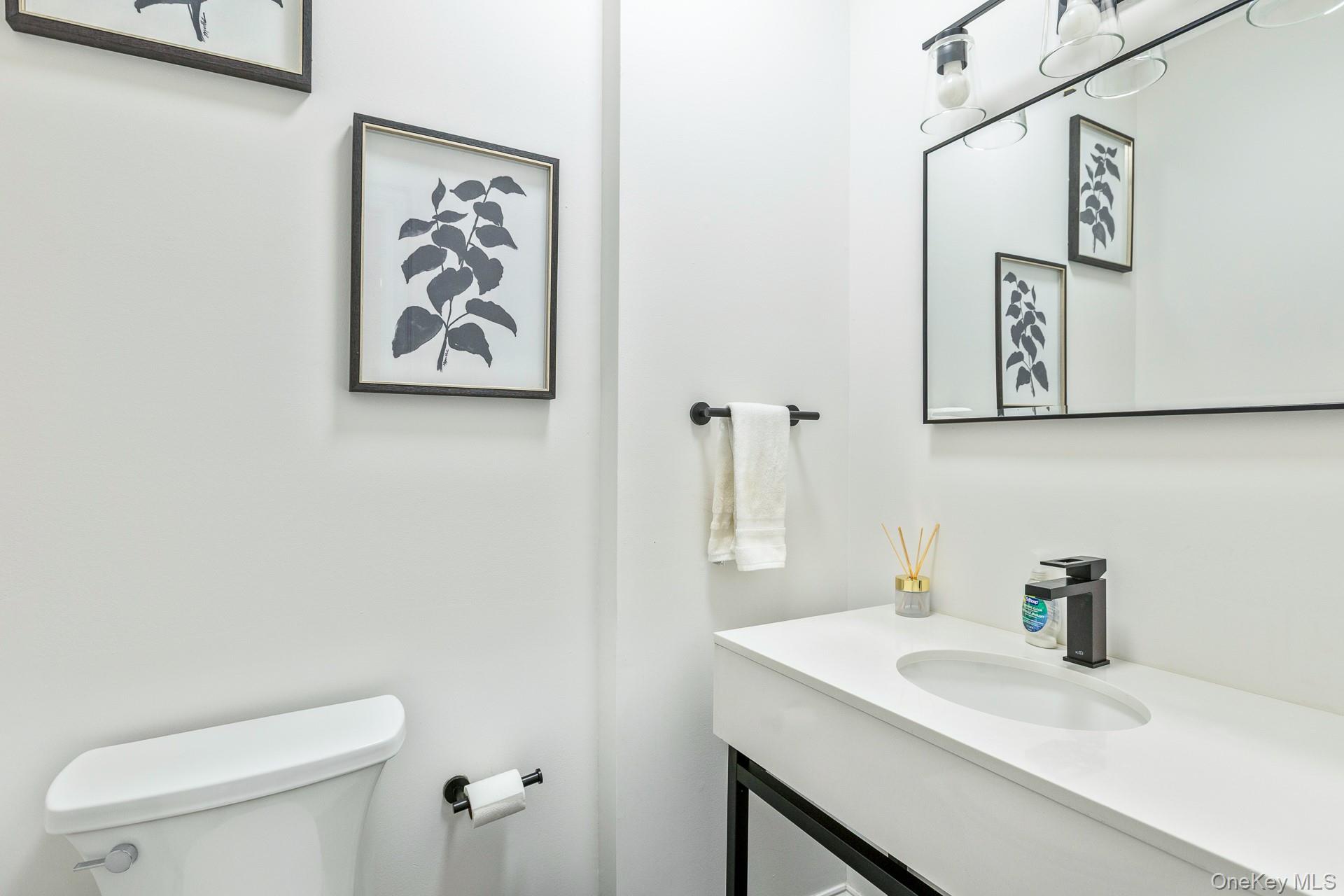 26 Box Tree Road East Quogue, NY 11942 - Photo 25 of 49 a bathroom with a toilet sink and mirror