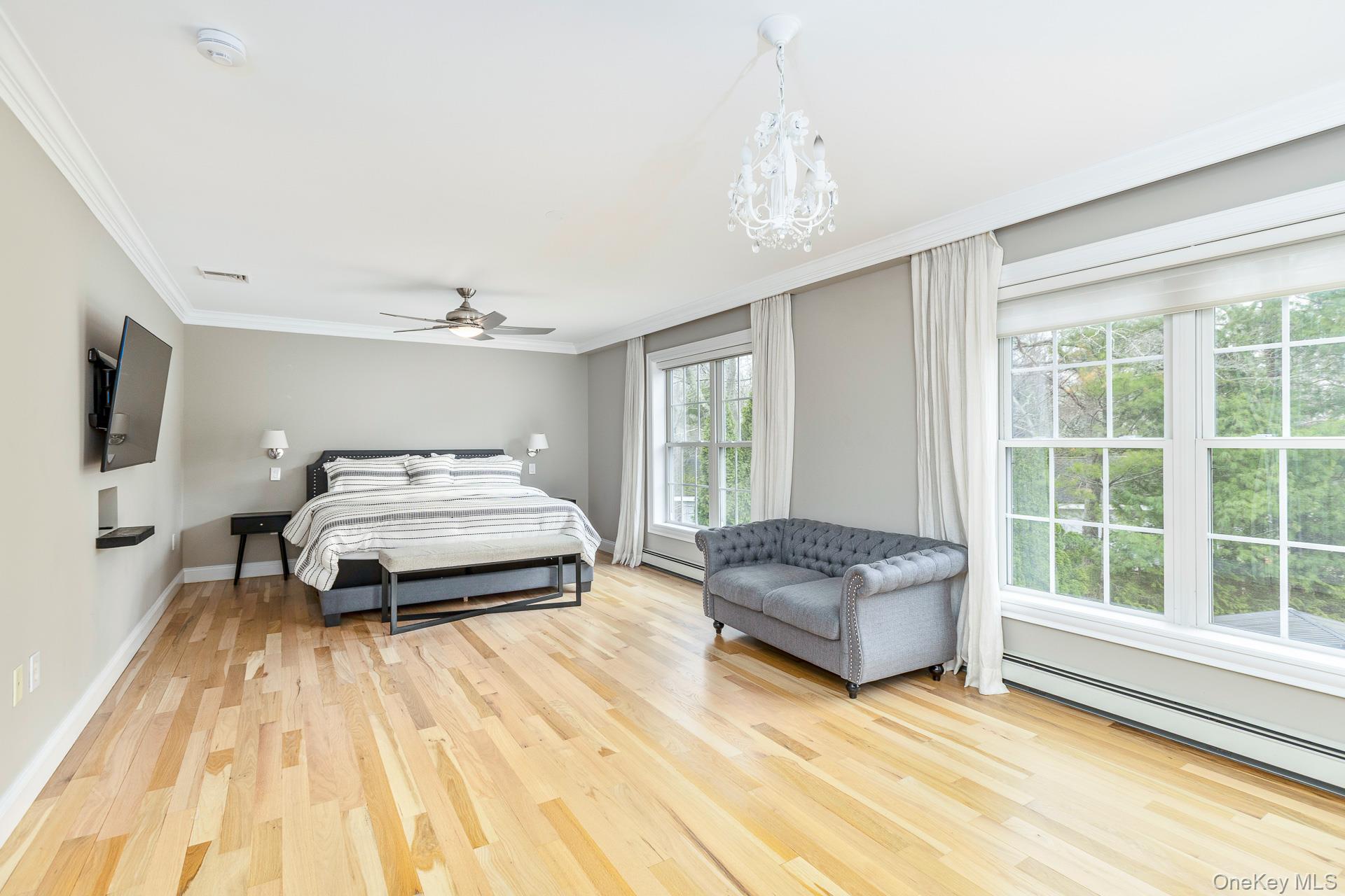 26 Box Tree Road East Quogue, NY 11942 - Photo 26 of 49 a bedroom with a bed and a window with balcony view
