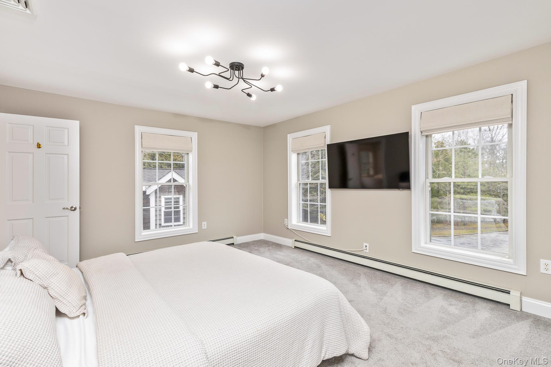 26 Box Tree Road East Quogue, NY 11942 - Photo 30 of 49 a bedroom with a large bed and a window