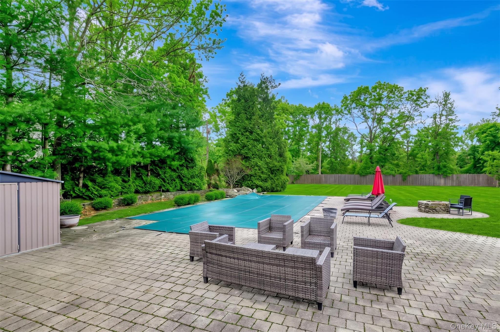 26 Box Tree Road East Quogue, NY 11942 - Photo 3 of 49 a backyard of a house with outdoor seating
