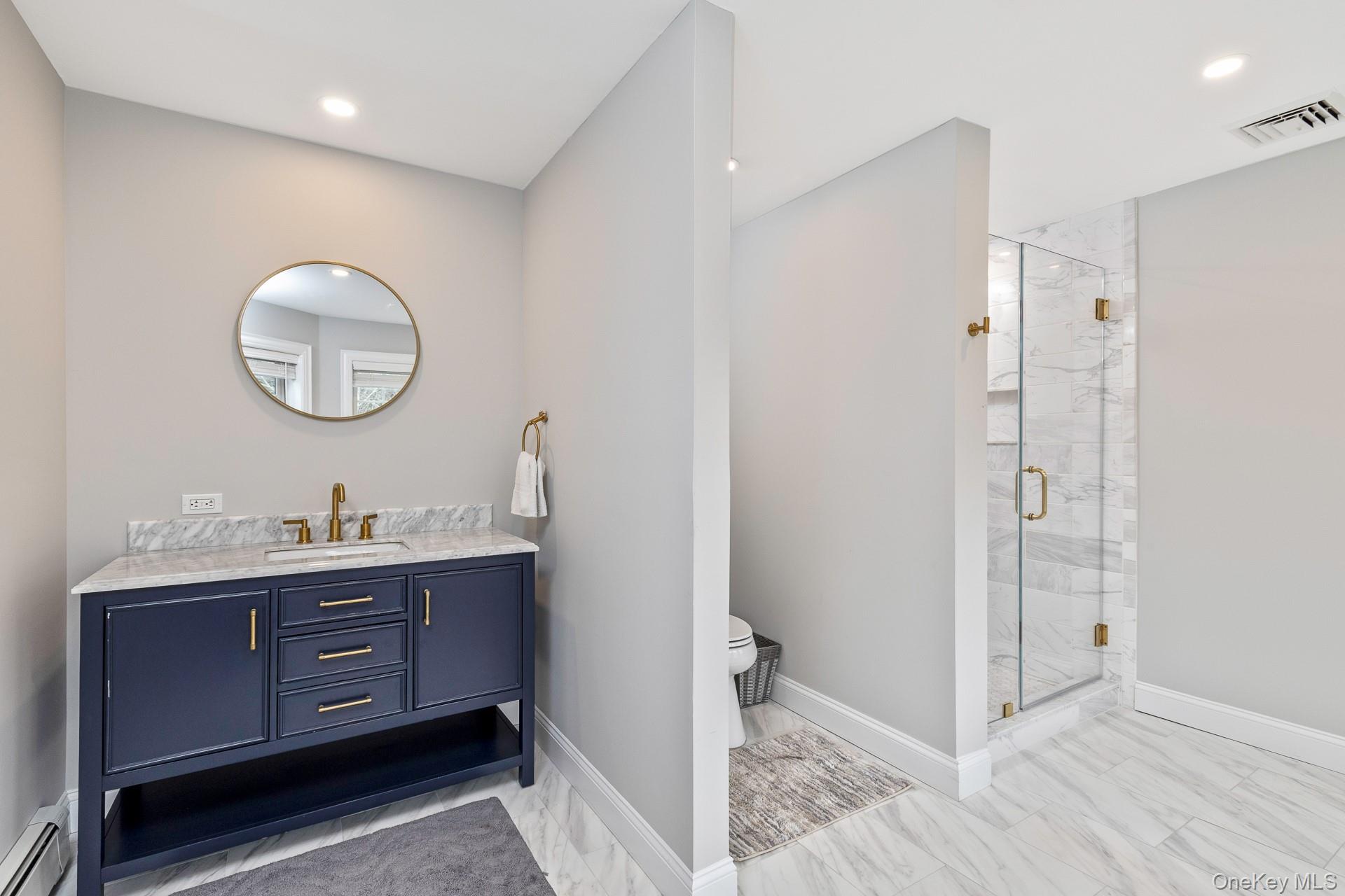 26 Box Tree Road East Quogue, NY 11942 - Photo 33 of 49 a bathroom with a sink and a mirror