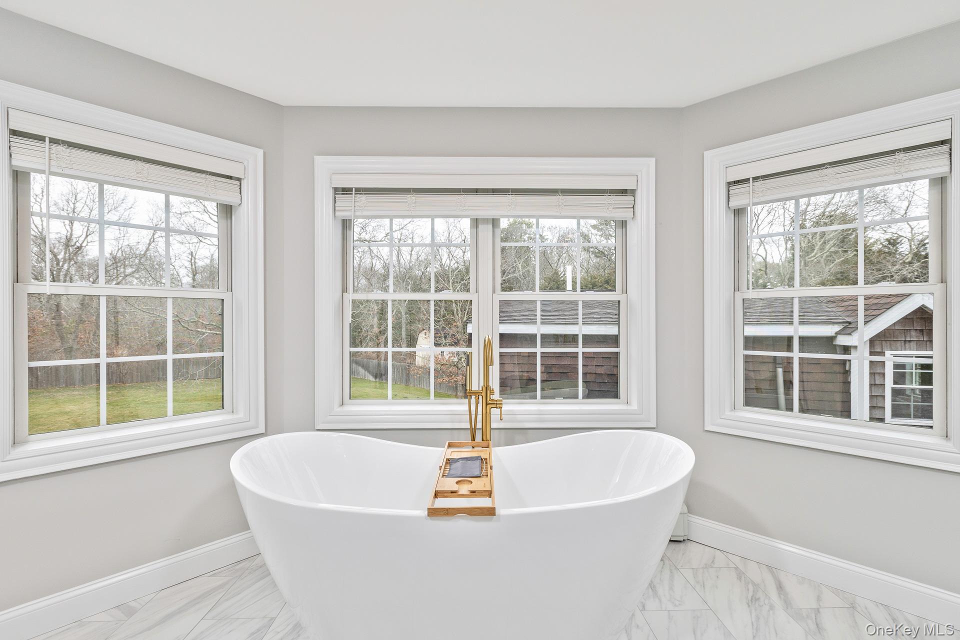 26 Box Tree Road East Quogue, NY 11942 - Photo 34 of 49 a white bath tub sitting next to a window