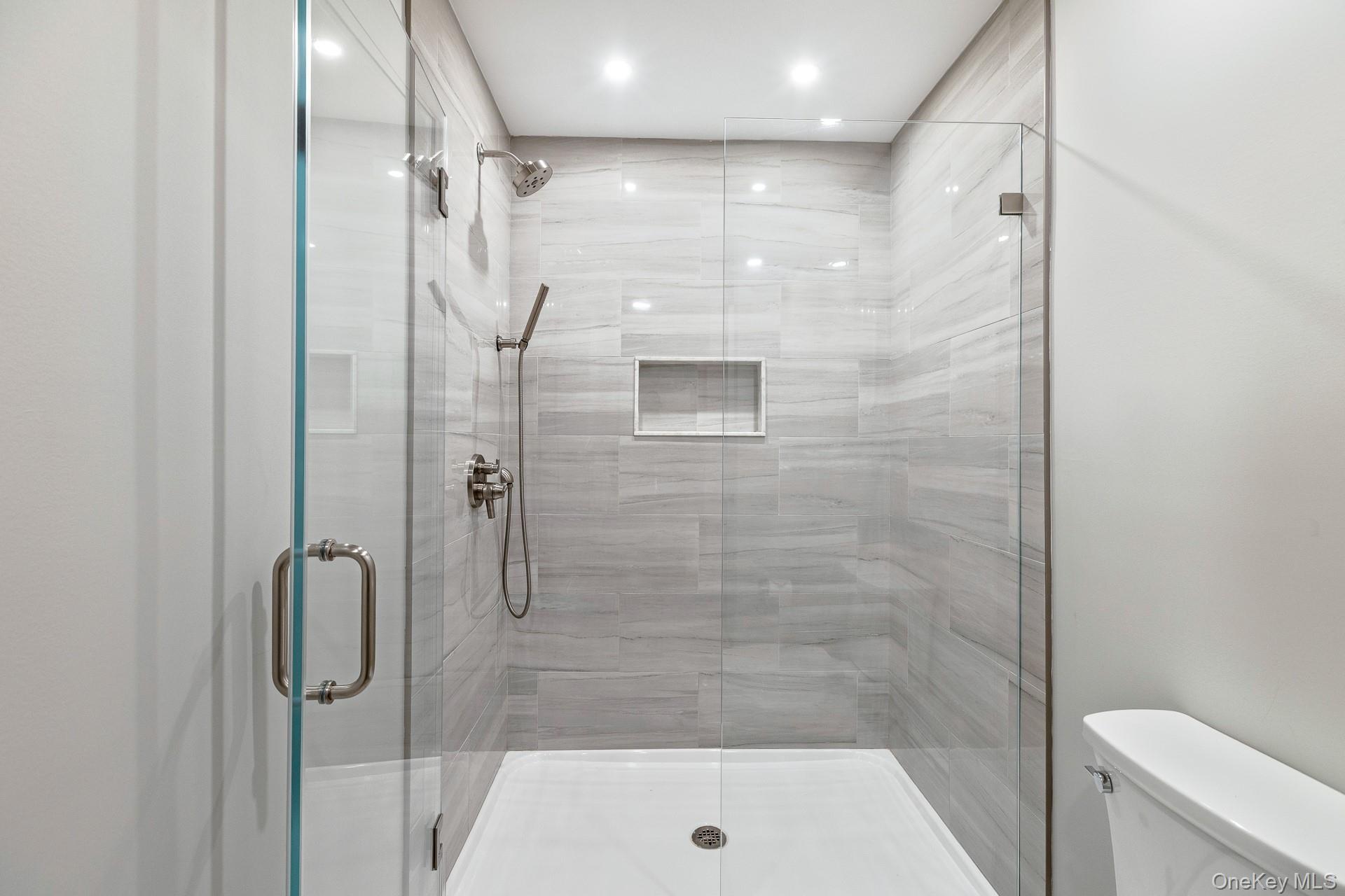 26 Box Tree Road East Quogue, NY 11942 - Photo 37 of 49 a bathroom with a shower and toilet