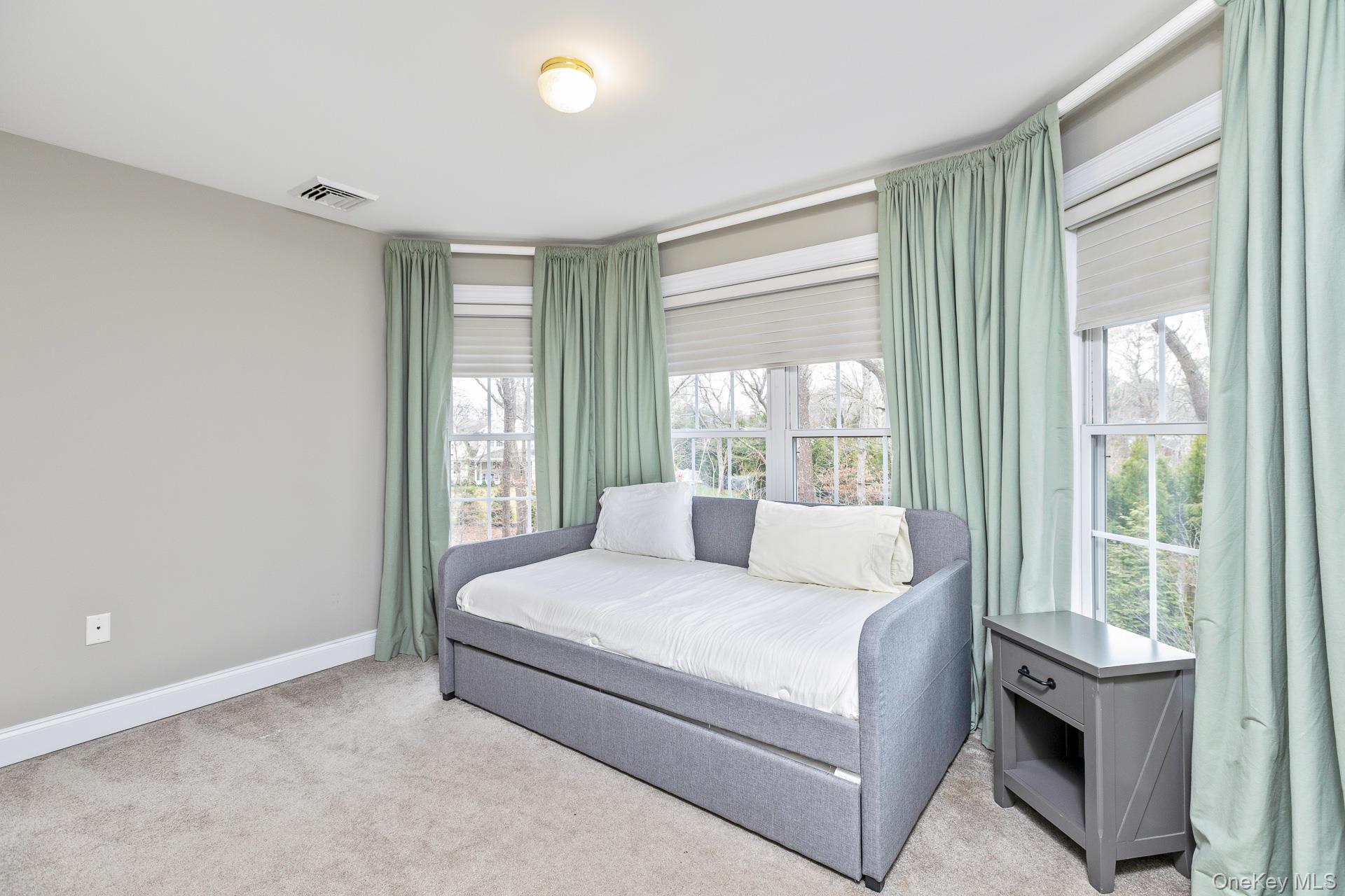 26 Box Tree Road East Quogue, NY 11942 - Photo 38 of 49 a bedroom with a large bed and a window