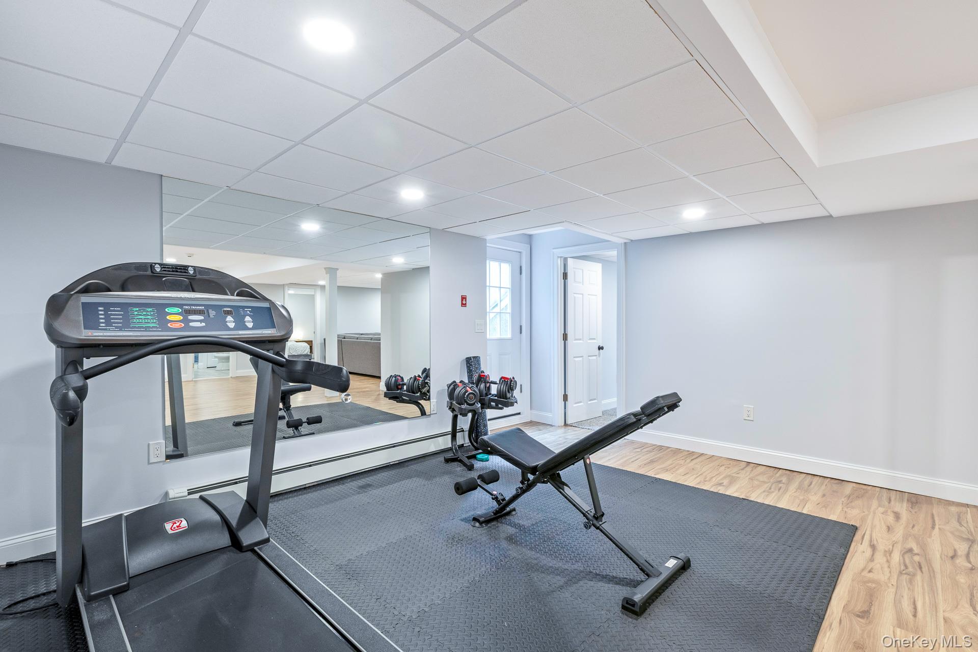 26 Box Tree Road East Quogue, NY 11942 - Photo 40 of 49 a living room with furniture gym equipment and a rug
