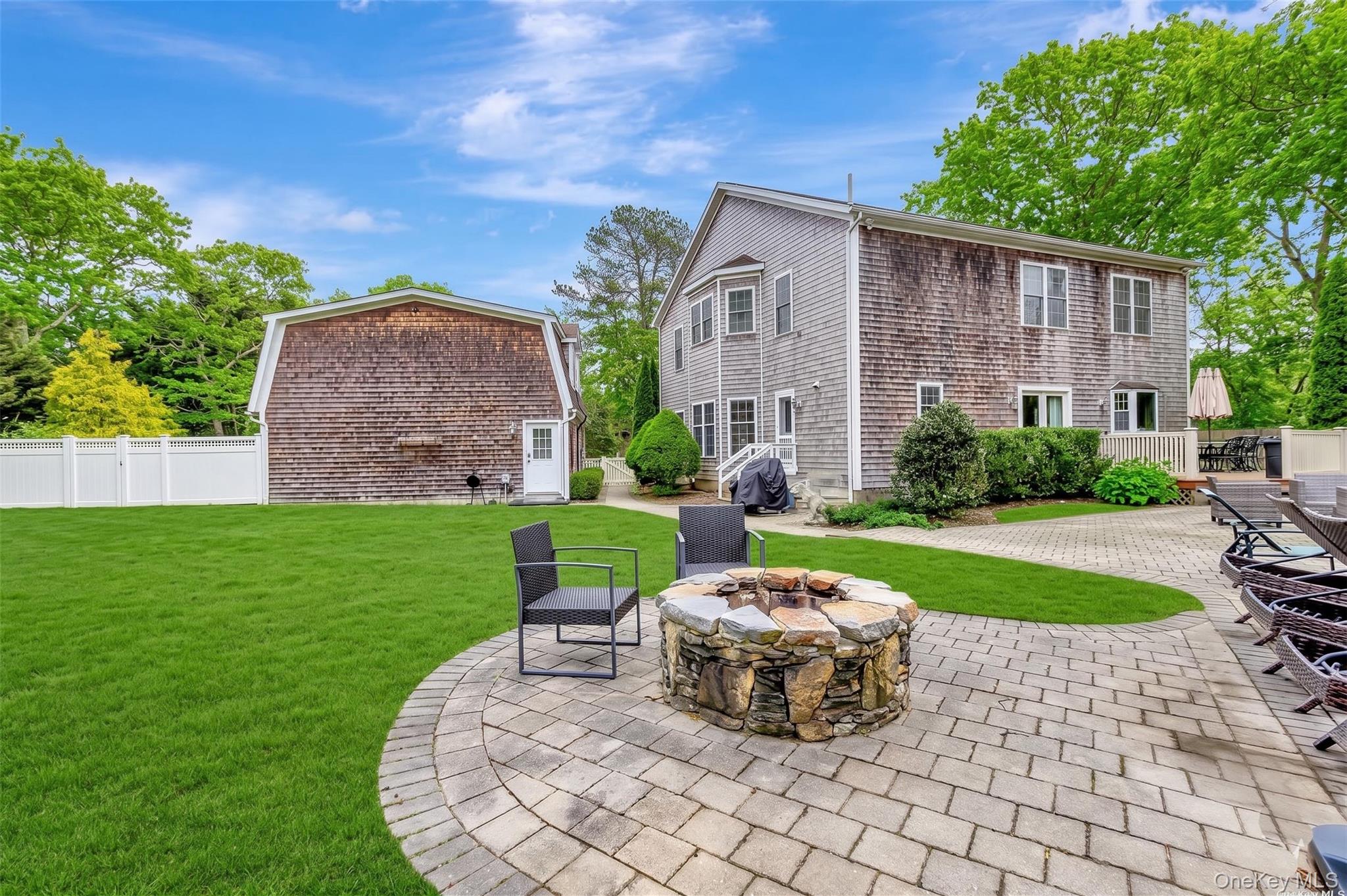 26 Box Tree Road East Quogue, NY 11942 - Photo 4 of 49 a view of a house with backyard sitting area and garden