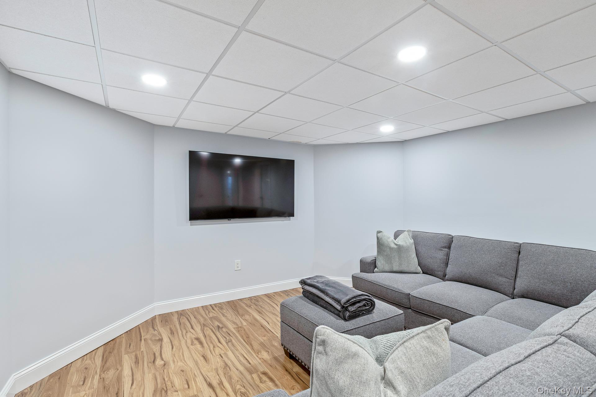 26 Box Tree Road East Quogue, NY 11942 - Photo 41 of 49 a living room with furniture and a flat screen tv