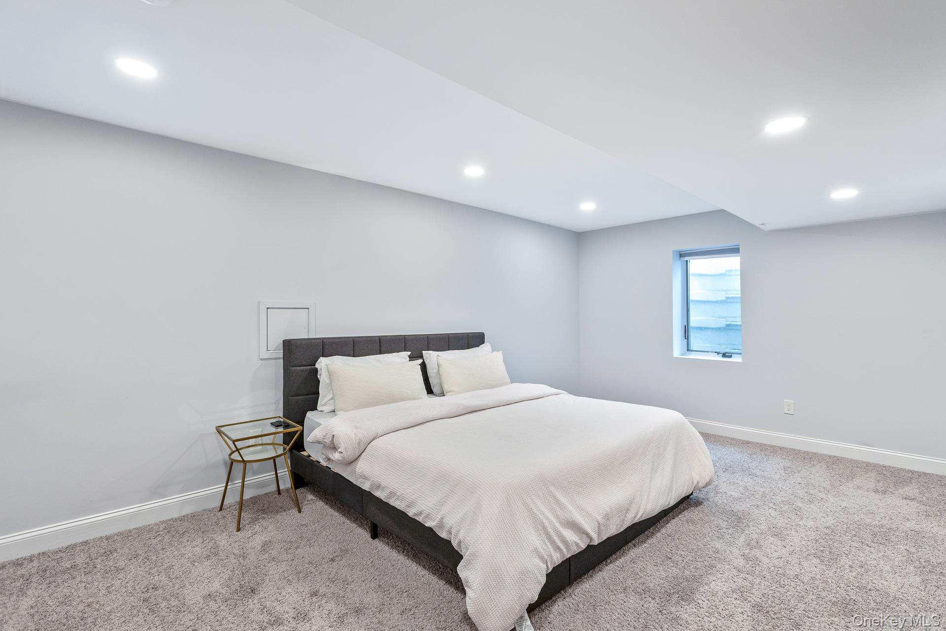 26 Box Tree Road East Quogue, NY 11942 - Photo 43 of 49 a bedroom with a bed and a window
