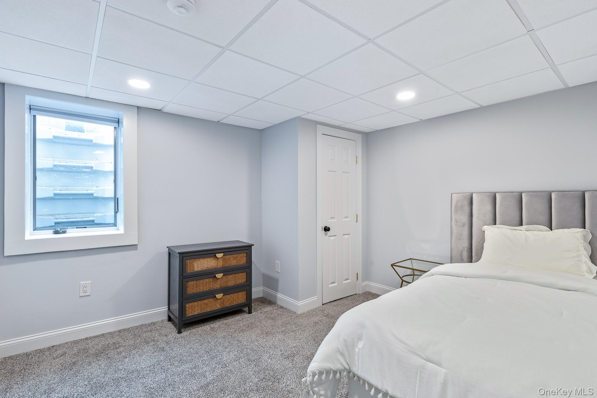 26 Box Tree Road East Quogue, NY 11942 - Photo 44 of 49 a bedroom with a bed and a window