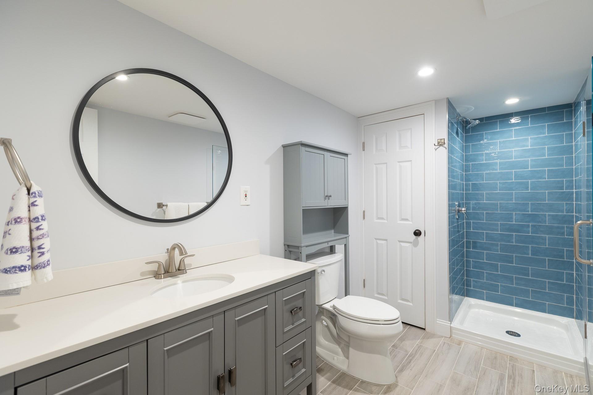 26 Box Tree Road East Quogue, NY 11942 - Photo 45 of 49 a bathroom with a sink a toilet and shower