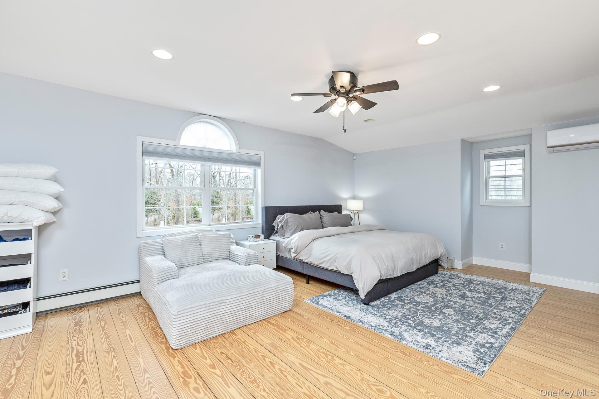 26 Box Tree Road East Quogue, NY 11942 - Photo 48 of 49 a spacious bedroom with a large bed and a window