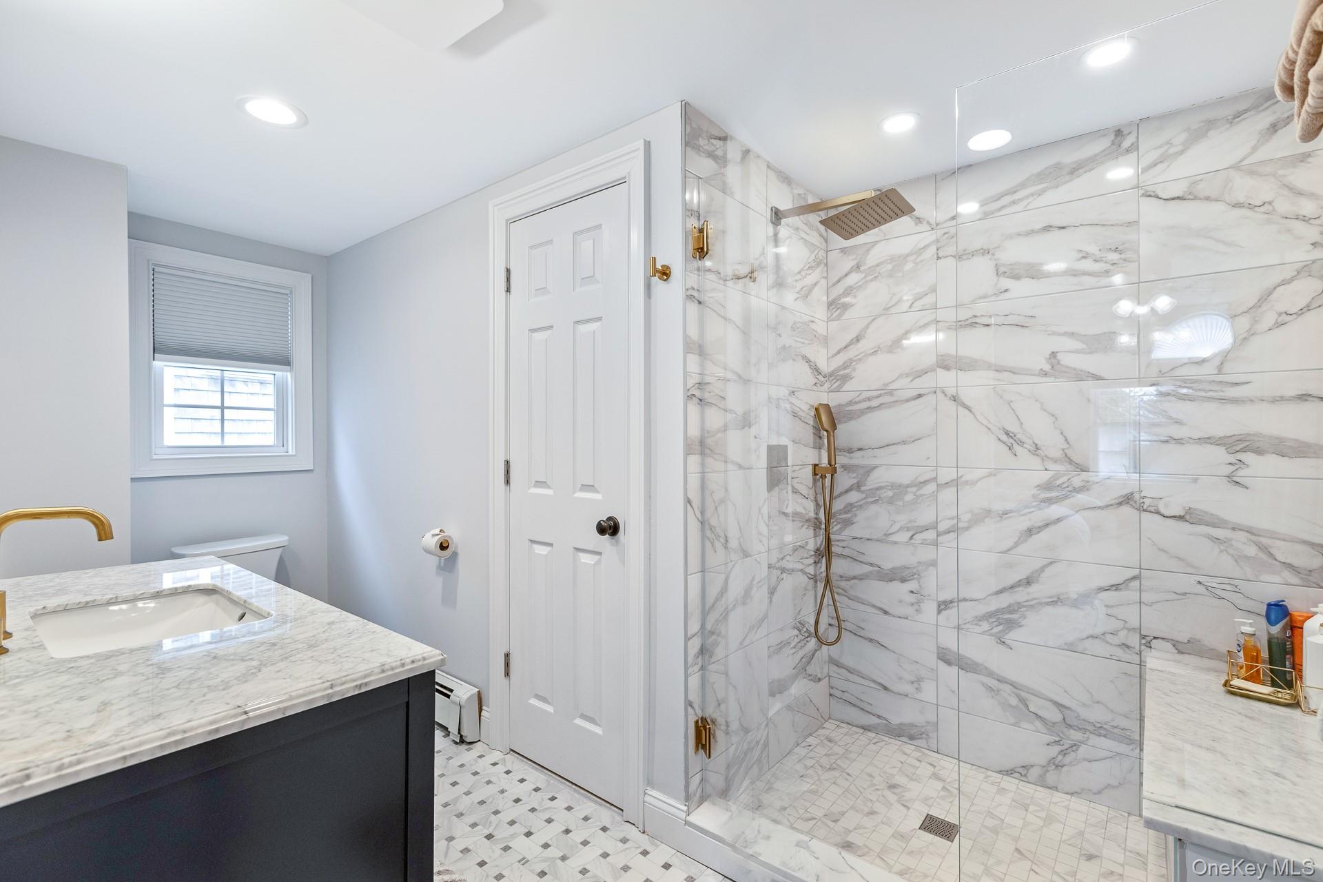 26 Box Tree Road East Quogue, NY 11942 - Photo 49 of 49 a bathroom with a granite countertop sink a mirror and shower