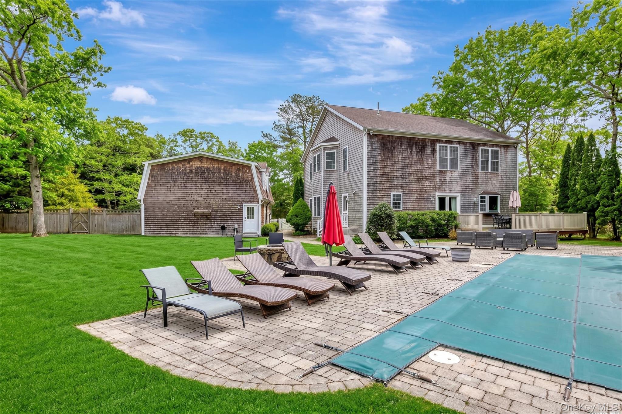 26 Box Tree Road East Quogue, NY 11942 - Photo 5 of 49 a view of a house with backyard sitting area and swimming pool