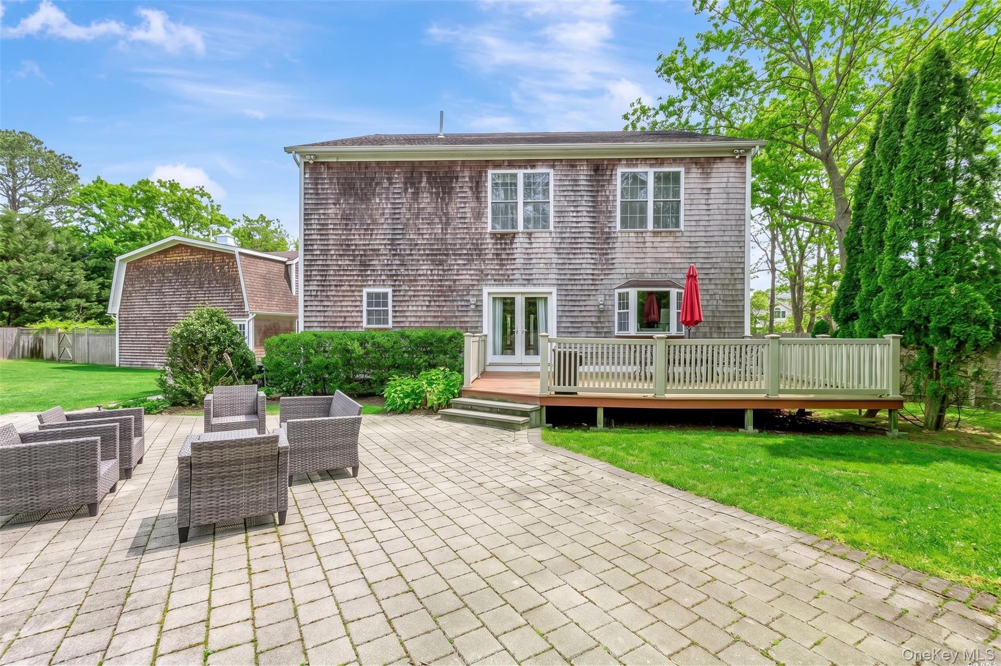 26 Box Tree Road East Quogue, NY 11942 - Photo 6 of 49 a front view of a house with garden