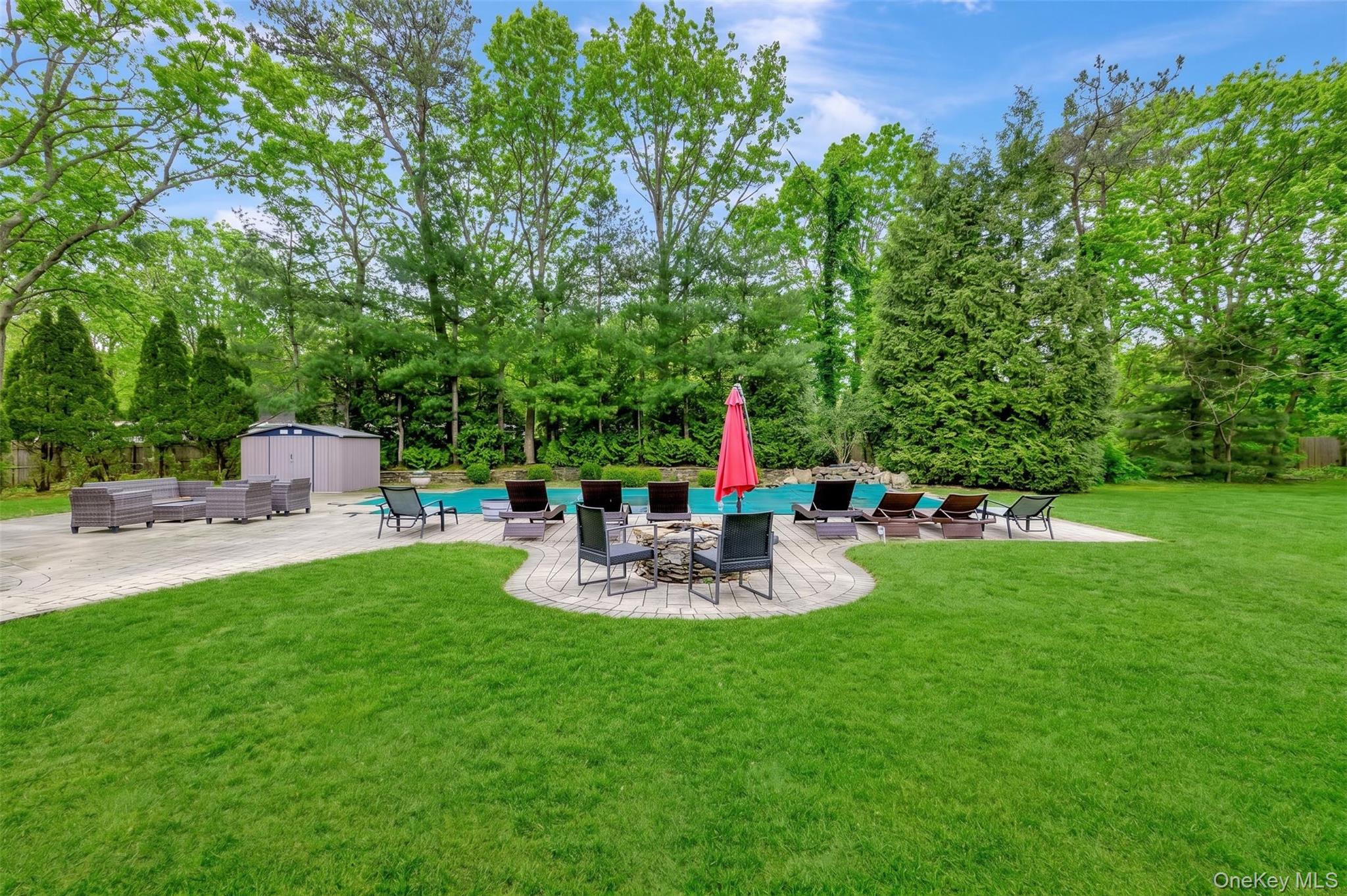 26 Box Tree Road East Quogue, NY 11942 - Photo 8 of 49 a view of backyard with seating and green space