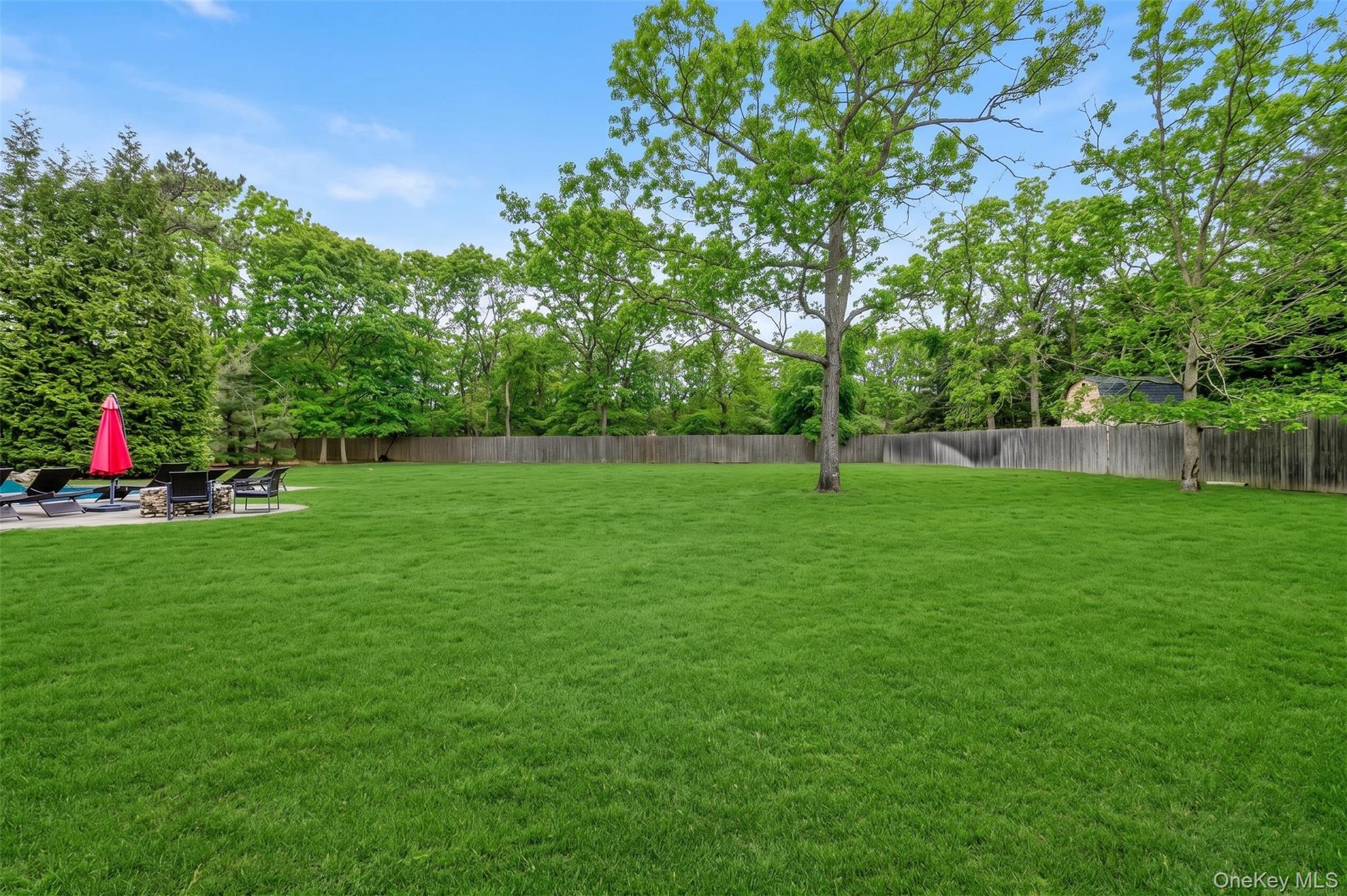 26 Box Tree Road East Quogue, NY 11942 - Photo 9 of 49 a view of green field with trees in the background