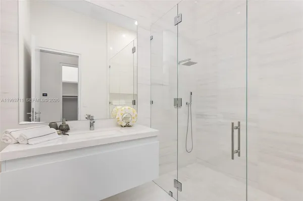 a bathroom with a double vanity sink and mirror