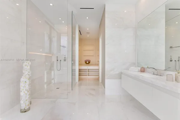an empty room with wooden floor and a floor to ceiling window