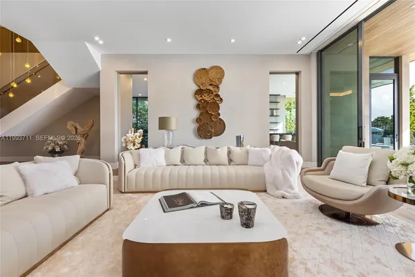 a kitchen with stainless steel appliances kitchen island white cabinets and a couch