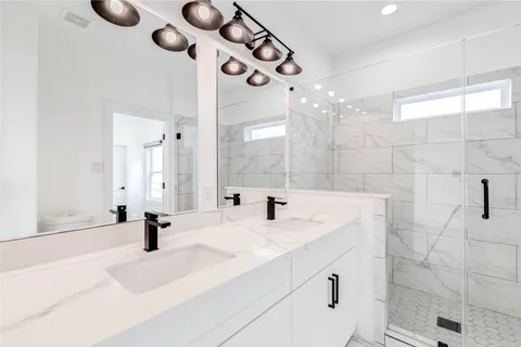 a bathroom with a sink a mirror and shower