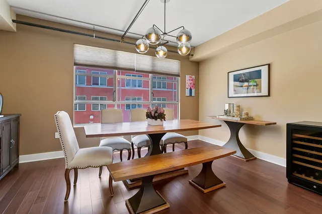 a view of a dining room with furniture wooden floor and chandelier