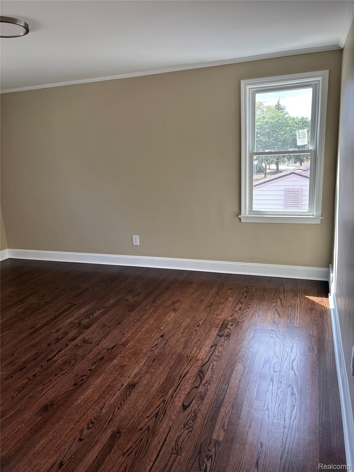 18259 Spring Court South Fraser, MI 48026 - Photo 26 of 60 Hardwood flooring, painted walls, white trim, and a window