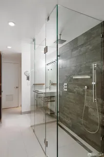 a bathroom with a glass shower door and a sink