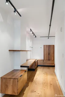 a living room with a couch and a dresser with wooden floor