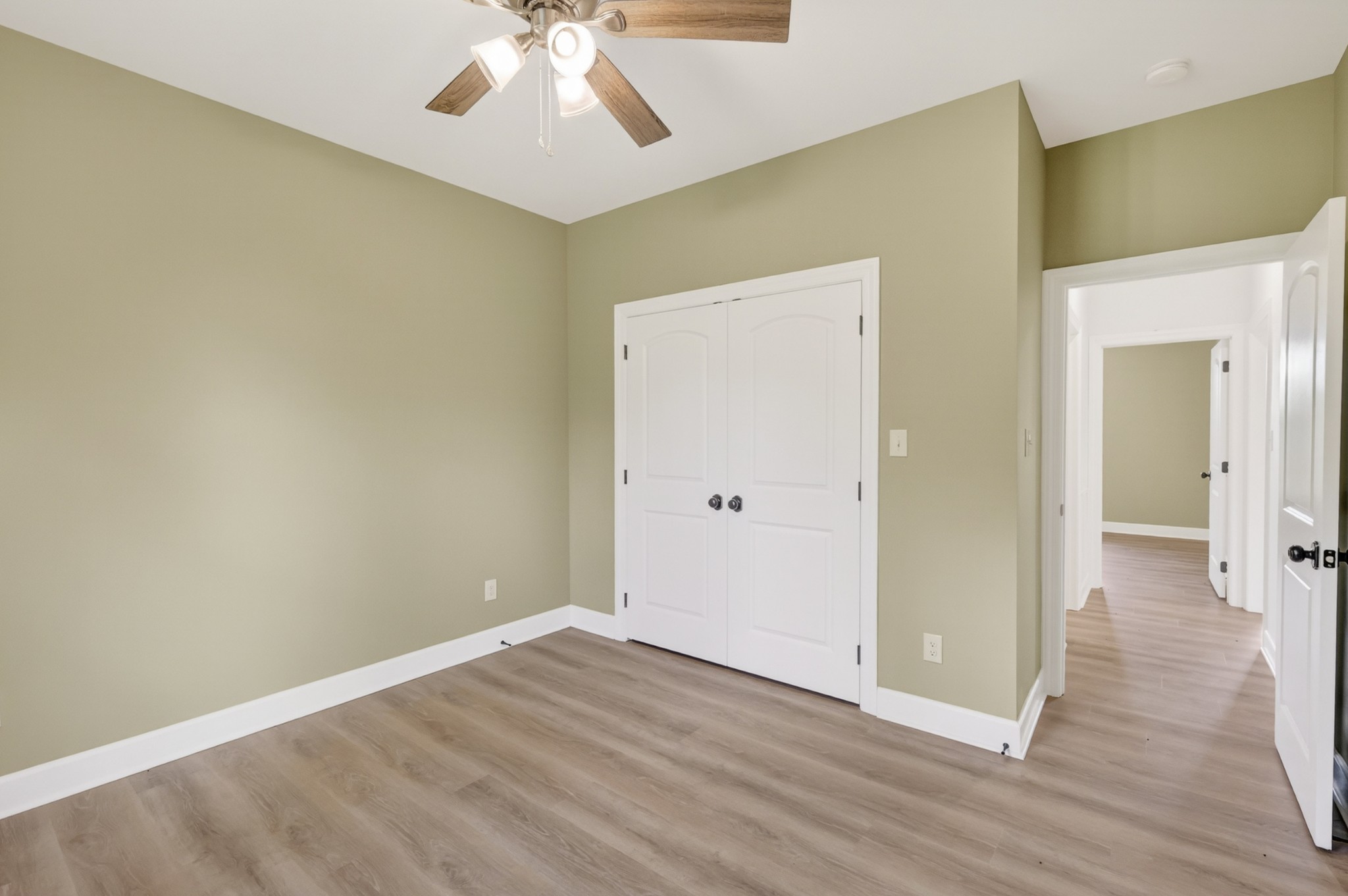8415 West Sheepneck Road Mount Pleasant, TN 38474 - Photo 21 of 40 a view of a room with wooden floor and a ceiling fan