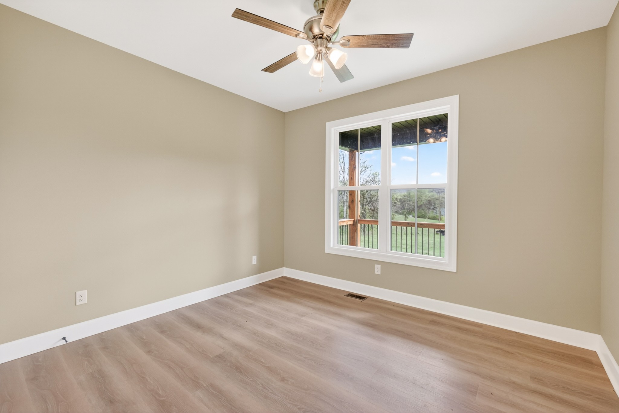 8415 West Sheepneck Road Mount Pleasant, TN 38474 - Photo 27 of 40 an empty room with a window and ceiling fan