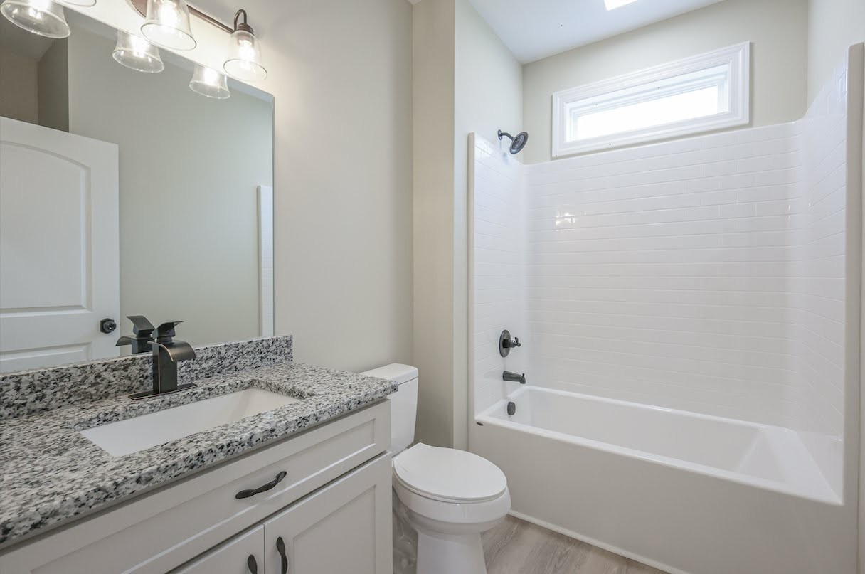 8415 West Sheepneck Road Mount Pleasant, TN 38474 - Photo 30 of 40 a bathroom with a granite countertop sink toilet and shower