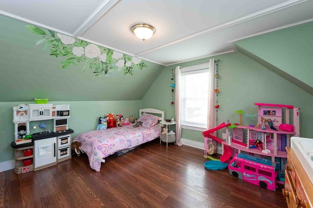 6 Monroe Court Gloucester, MA 01930 - Photo 22 of 41 a bedroom with a bed and a wooden floor