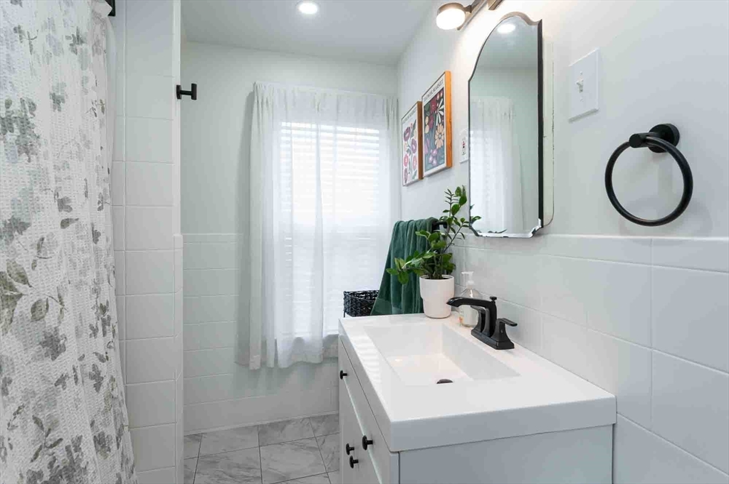 6 Monroe Court Gloucester, MA 01930 - Photo 25 of 41 a bathroom with a sink and a mirror