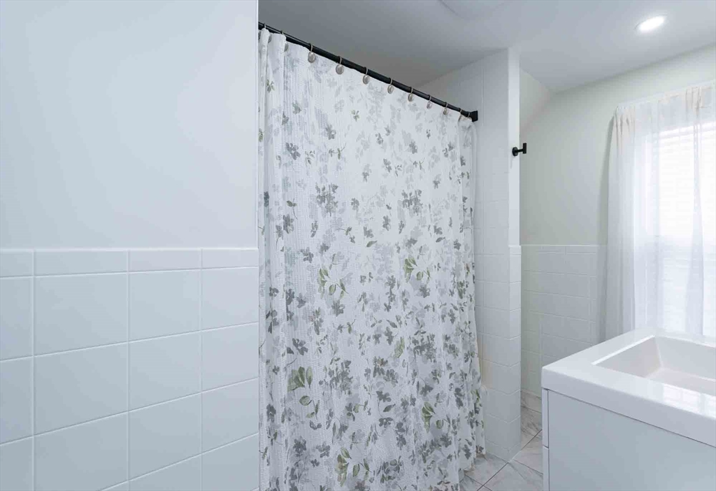 6 Monroe Court Gloucester, MA 01930 - Photo 26 of 41 a bathroom with a shower curtain and a sink