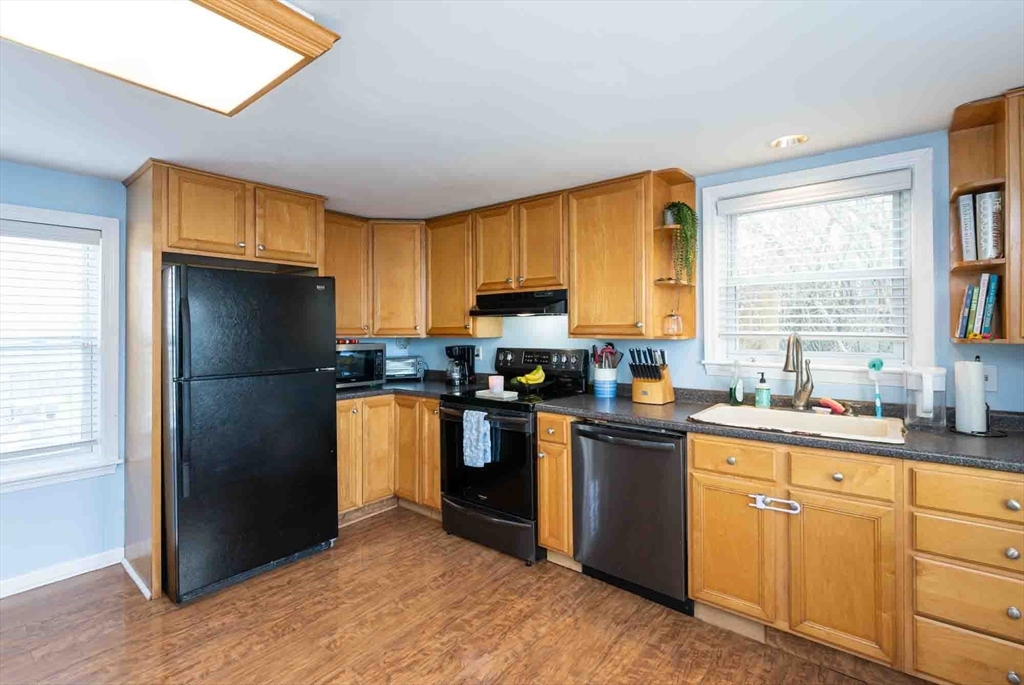 6 Monroe Court Gloucester, MA 01930 - Photo 6 of 41 a kitchen with granite countertop stainless steel appliances a refrigerator cabinets and a window