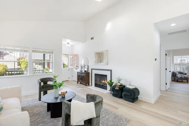 a living room with furniture a fireplace and a table