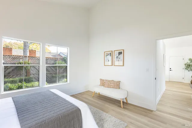 a bedroom with a bed and a large window