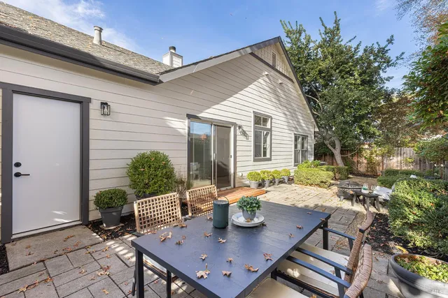 a view of a house with backyard and sitting area