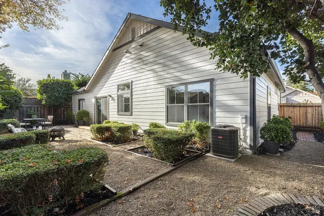 a front view of house with yard and outdoor seating