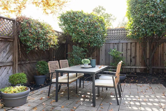 a outdoor space with a table and chairs