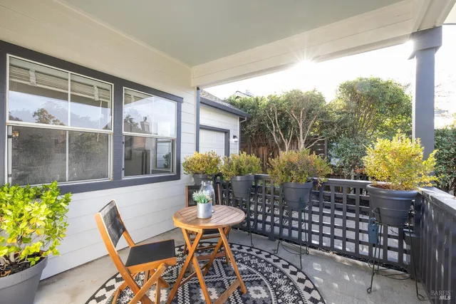a view of a patio with table and chairs and potted plants