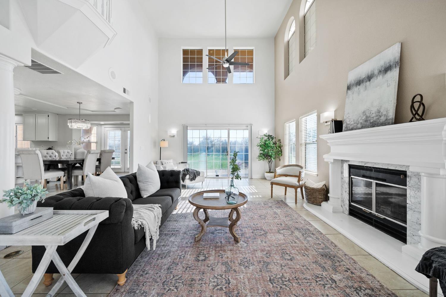 6312 Skittone Road Modesto, CA 95356 - Photo 15 of 93 a living room with furniture a fireplace and a large window