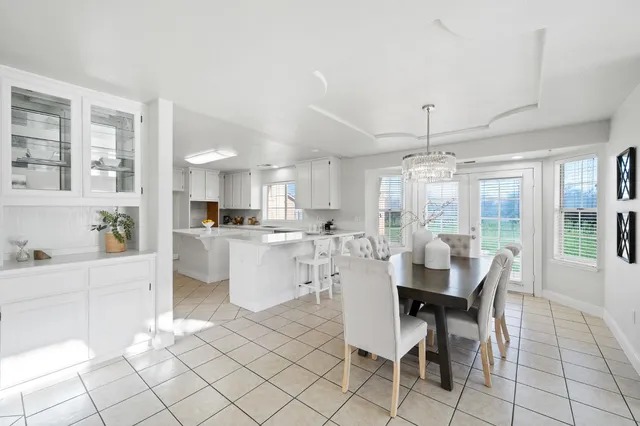 a spacious bathroom with a tub sink and mirror