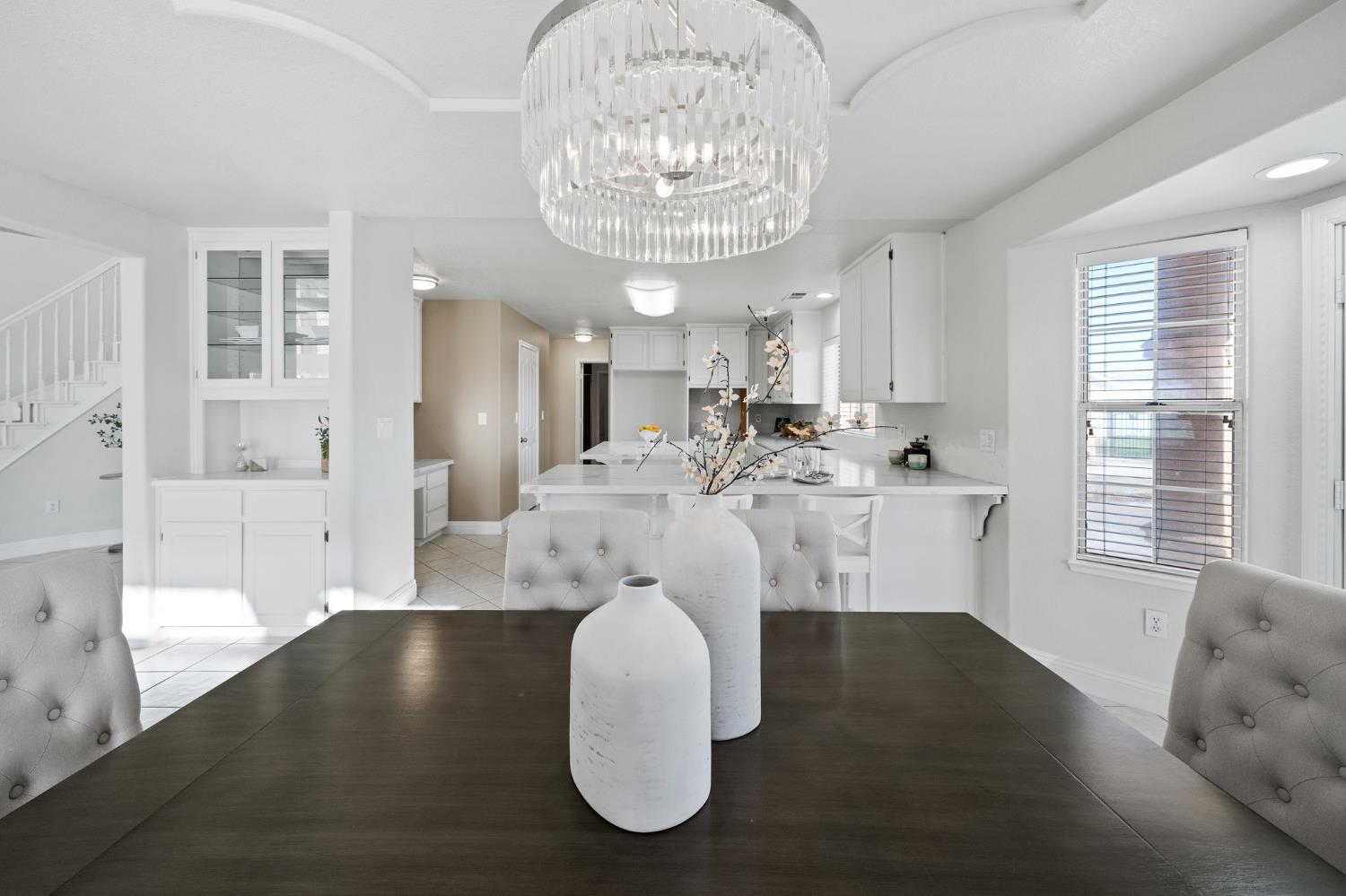 6312 Skittone Road Modesto, CA 95356 - Photo 19 of 93 a view of a dining room with furniture wooden floor and chandelier