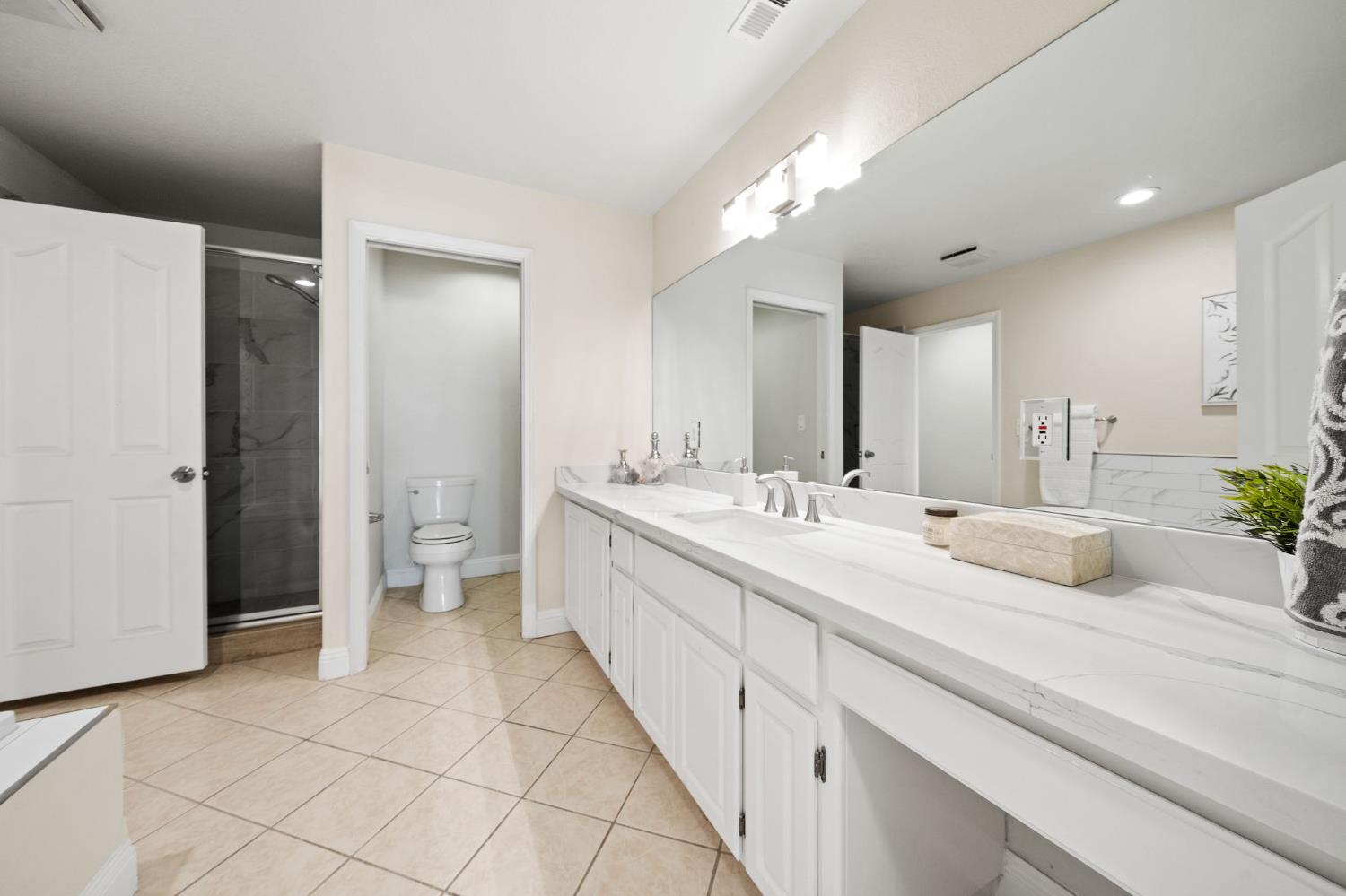 6312 Skittone Road Modesto, CA 95356 - Photo 29 of 93 a spacious bathroom with a double vanity sink mirror and toilet