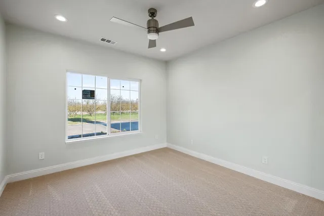 a bedroom with a bed a couch and a dresser with wooden floor